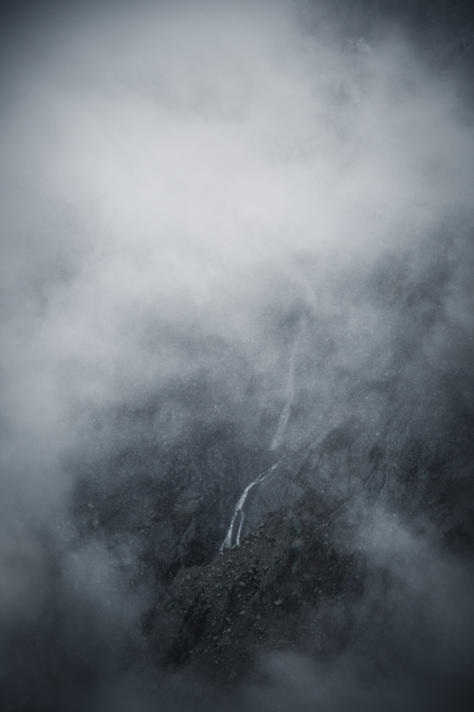 photograph of chamonix waterfall just visible through dense mists by mayank thammalla 02