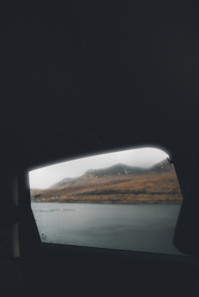 photograph of iceland's faroe islands shoreline through a foggy window by mayank thammalla