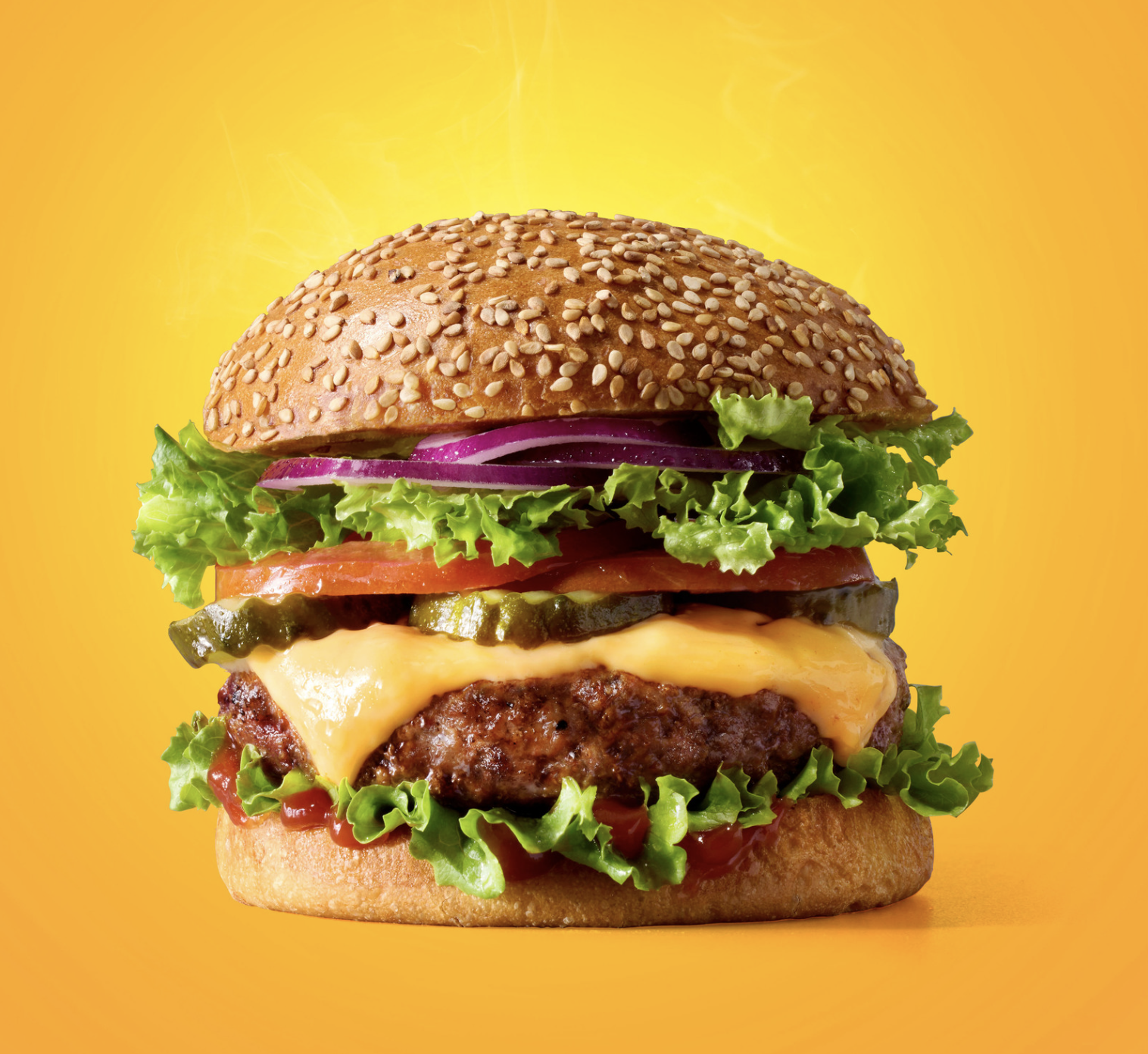 photo of juicy cheeseburger on a yellow background by Nadim Sabella