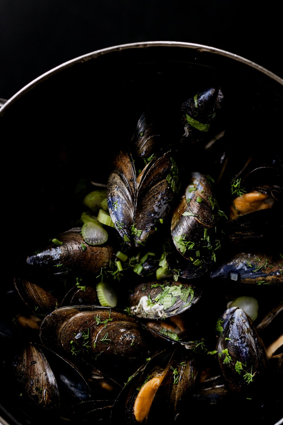 photo of mussels in a bowl with celery and herbs by Ashleigh Britten