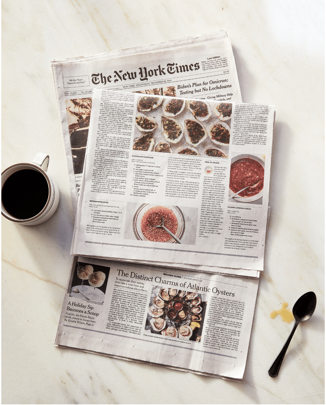 photo of the food section of the NYT on a marble counter beside a coffee cup and spoot by Joel Goldberg