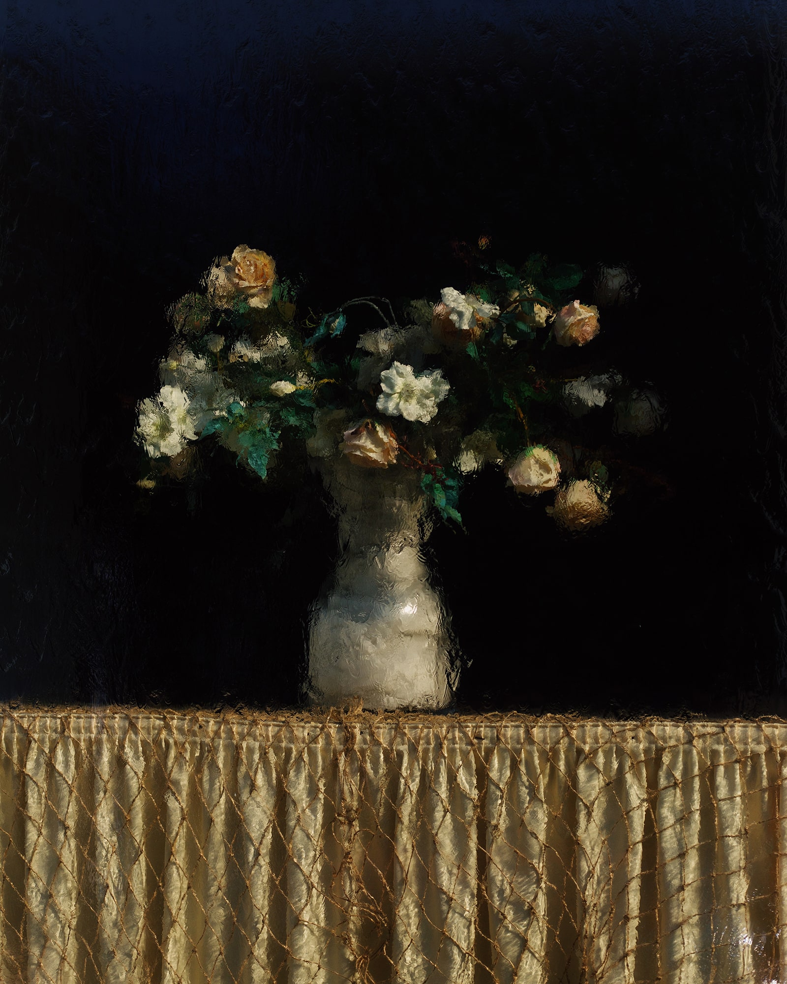 photograph of flowers in a vase on a table topped with gold cloth by Alice Angelini