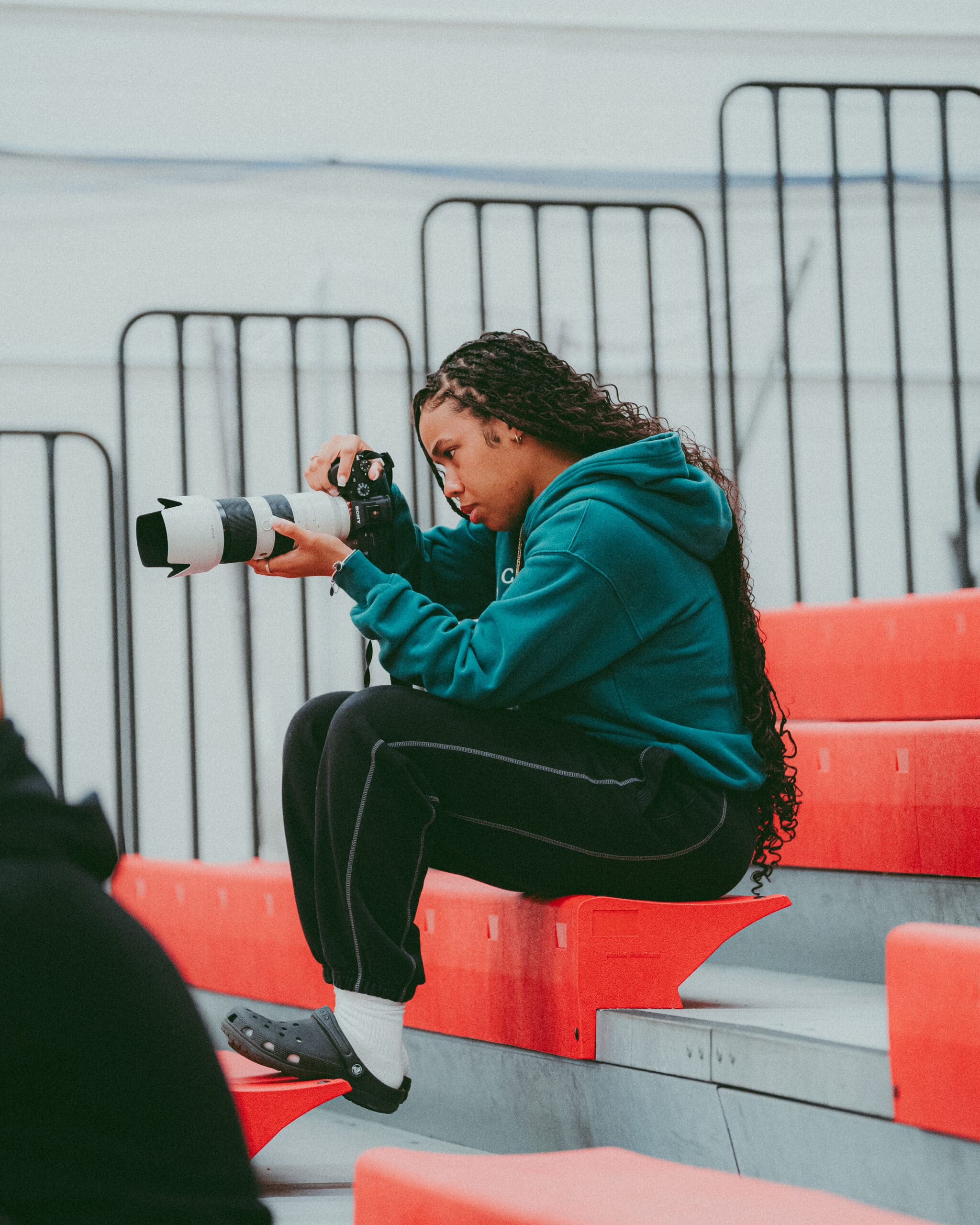 female youth member of Kickback Portfolio program looking at camera in auditorium seating